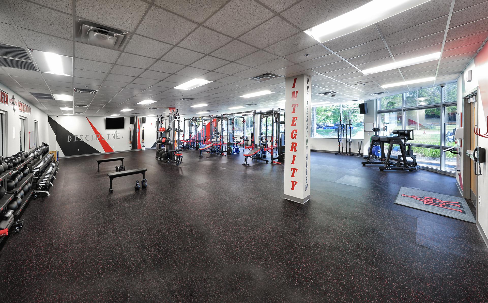 Fire department training gym with equipment and motivational words on walls